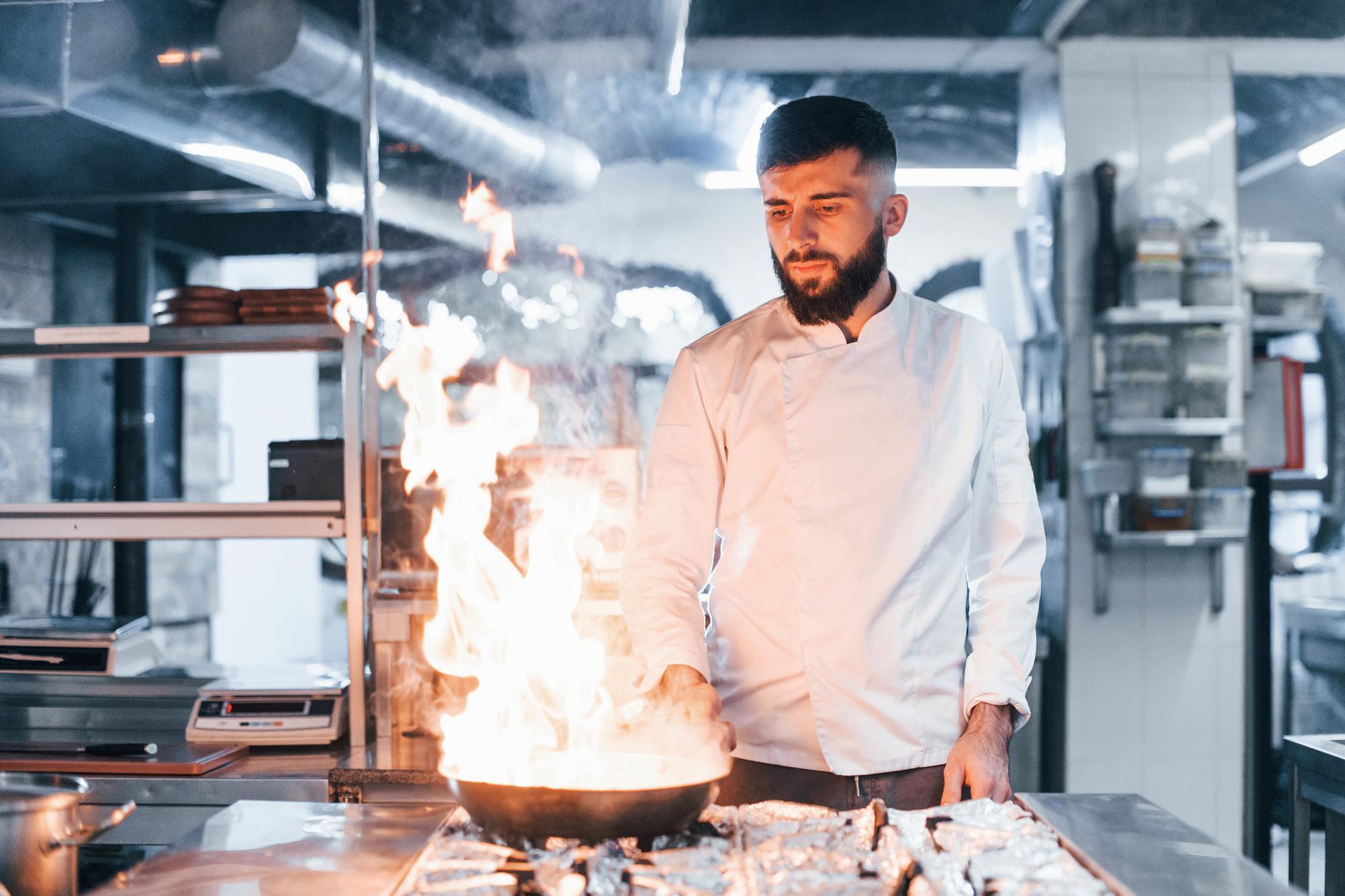 Chef at precision stove plating a course